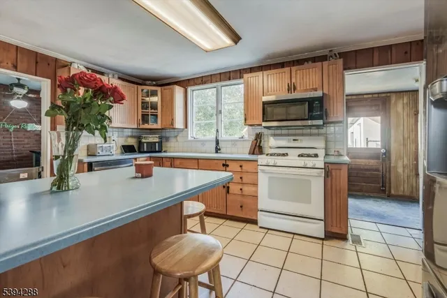 a kitchen with a sink a stove and cabinets