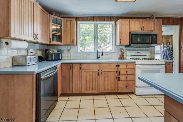 a kitchen with a sink a stove and cabinets