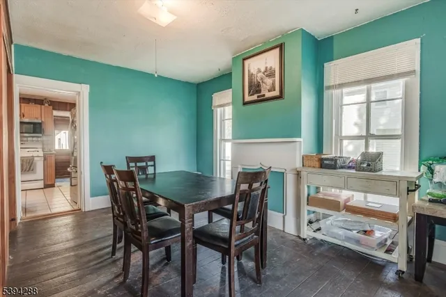 a view of a dining room with furniture and chandelier