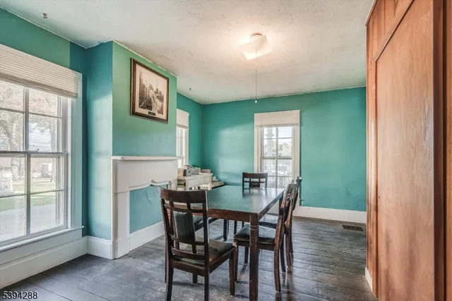 a view of a dining room with furniture and a window
