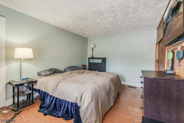 a bedroom with a bed a table and chair