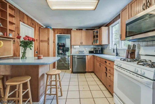 a kitchen with stainless steel appliances a sink and a stove