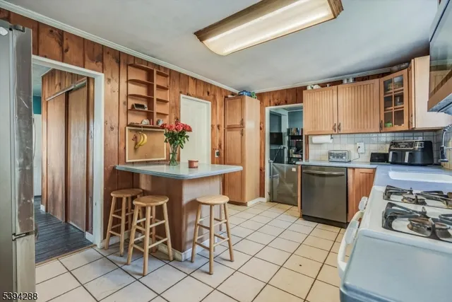 a kitchen with cabinets and chairs