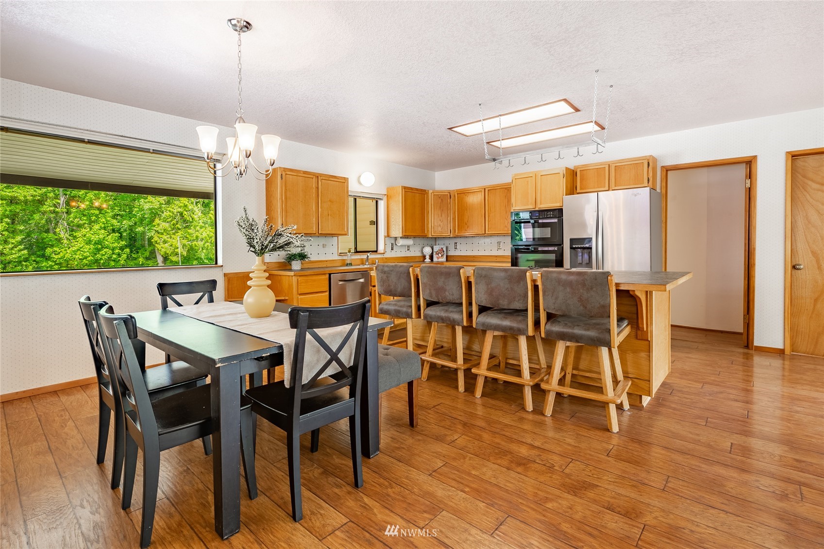 5604 Starry Road Bellingham, WA 98226 - Photo 4 of 40 a view of a dining room with furniture window and wooden floor