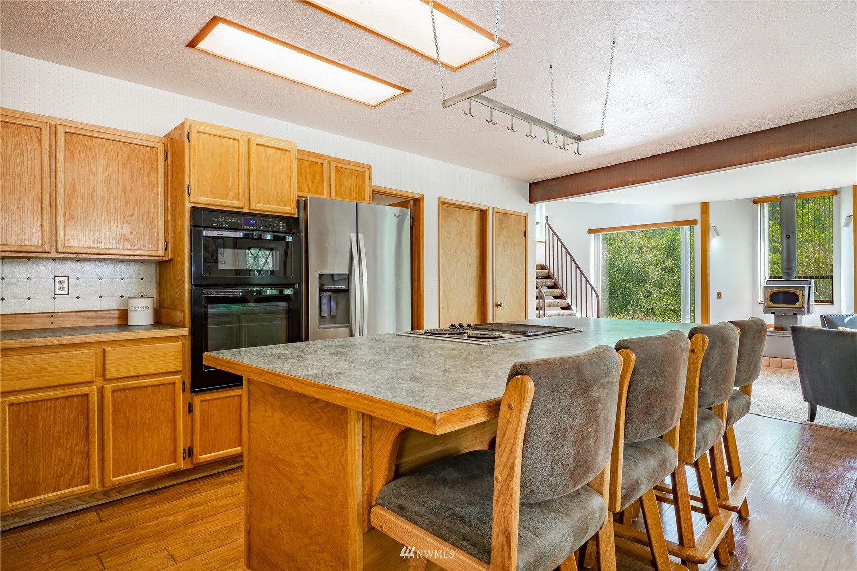 5604 Starry Road Bellingham, WA 98226 - Photo 6 of 40 a view of kitchen with stainless steel appliances wooden floor dining table and chairs