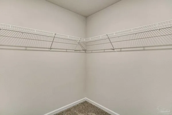 a bedroom with a large bed and a book shelf