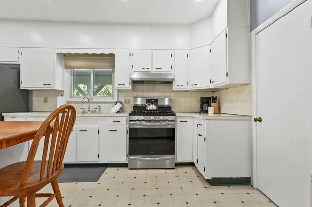 a kitchen with a stove a sink and a refrigerator