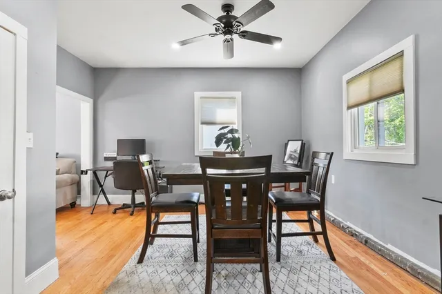 a view of a dining room with furniture and a window