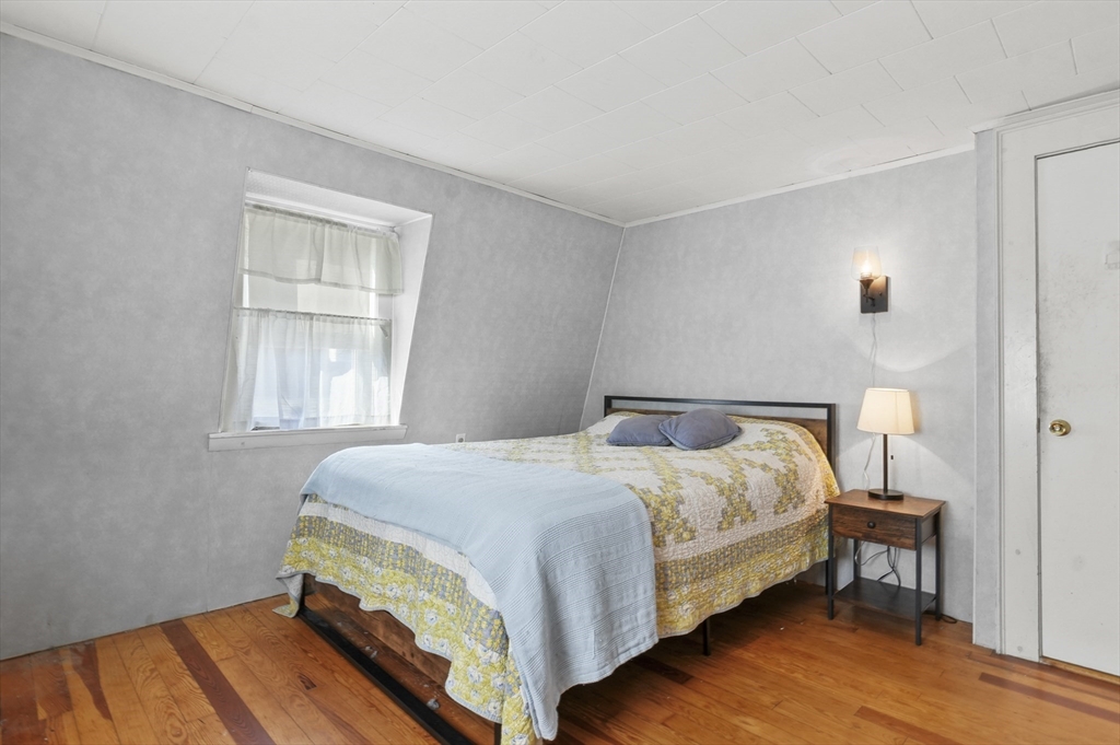 69 Eastern Avenue Woburn, MA 01801 - Photo 17 of 30 a bedroom with a bed table and a window