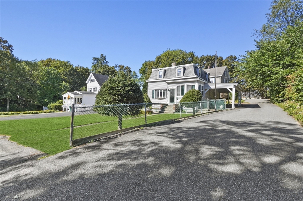 69 Eastern Avenue Woburn, MA 01801 - Photo 2 of 30 a view of a house with a big yard plants and large trees