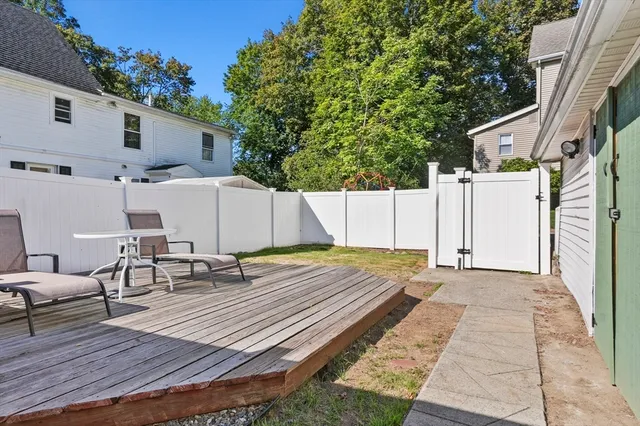 a view of a dinning table and chairs in patio of the house
