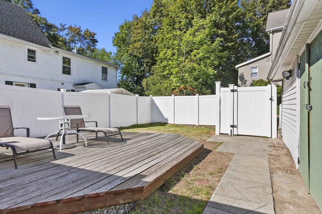 69 Eastern Avenue Woburn, MA 01801 - Photo 26 of 30 a view of a dinning table and chairs in patio of the house