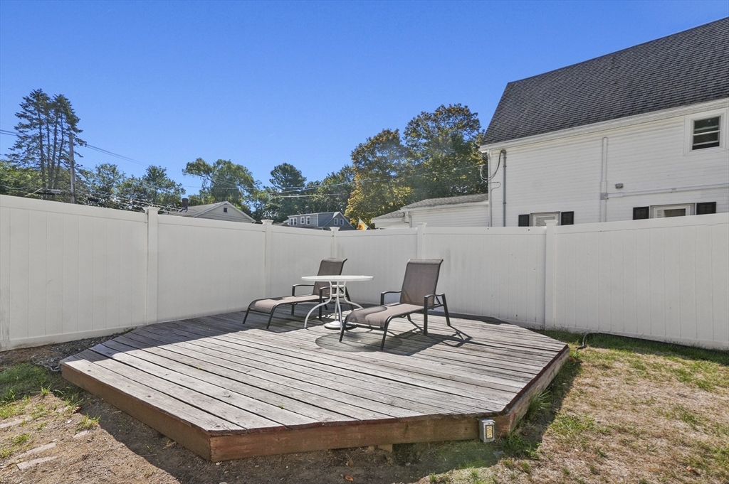 69 Eastern Avenue Woburn, MA 01801 - Photo 27 of 30 a view of a patio with a table and chairs