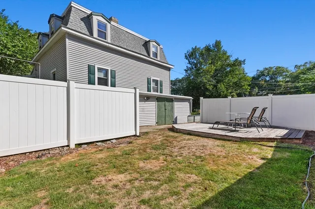 a view of a house with backyard and sitting area