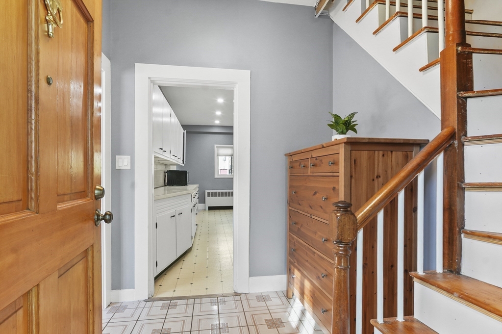 69 Eastern Avenue Woburn, MA 01801 - Photo 4 of 30 a view of a hallway with wooden floor and staircase