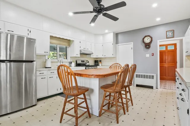 a dining room with furniture a window and stainless steel appliances