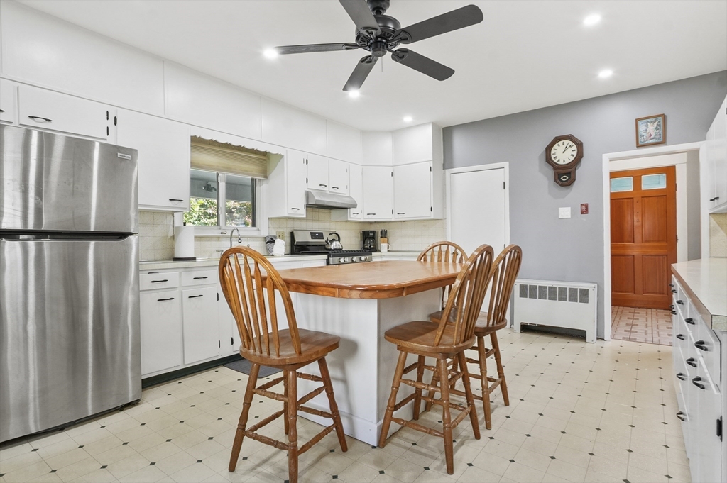 69 Eastern Avenue Woburn, MA 01801 - Photo 8 of 30 a dining room with furniture a window and stainless steel appliances