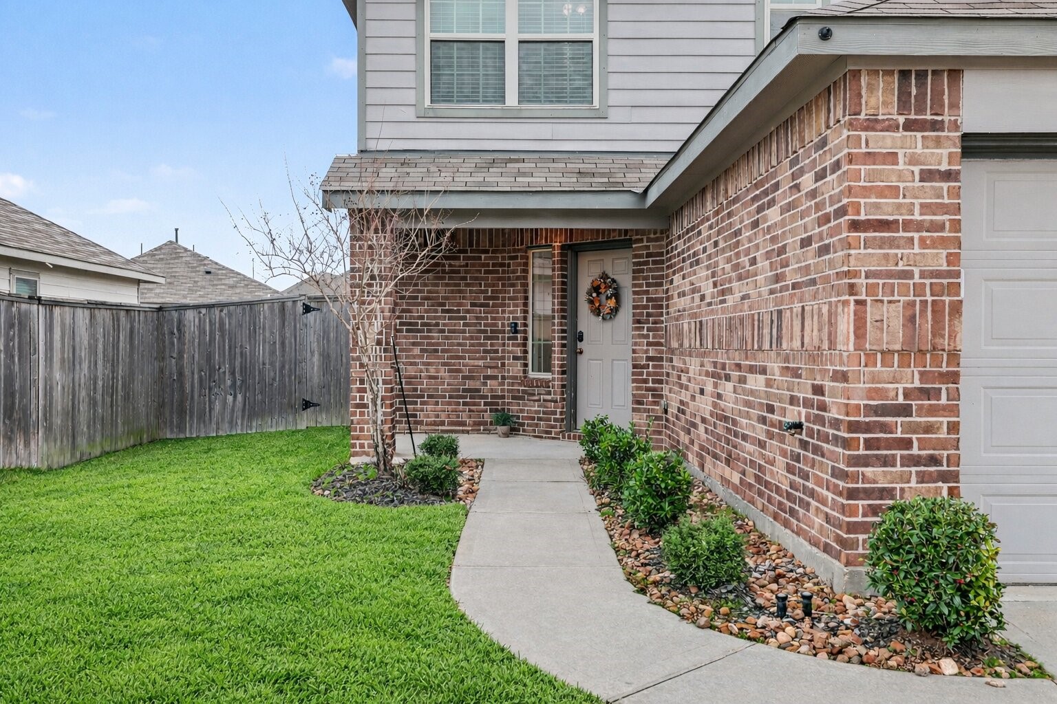 5929 Rimini Landing Lane Porter, TX 77365 - Photo 2 of 34 Charming front entry with a defined walkway and inviting front elevation. Photo enhanced for grass color only.