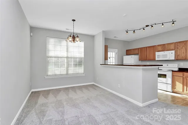 a kitchen with granite countertop a sink stove and refrigerator