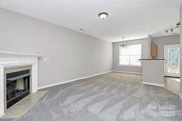 a view of an empty room with a fireplace