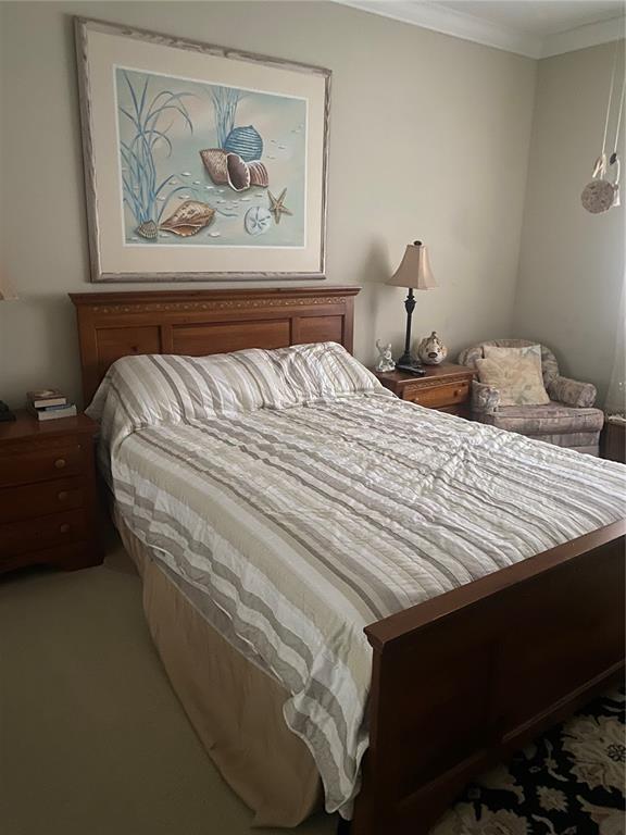60 Surfview Drive, Unit 121 Palm Coast, FL 32137 - Photo 11 of 13 a bed sitting in a bedroom next to a cabinet