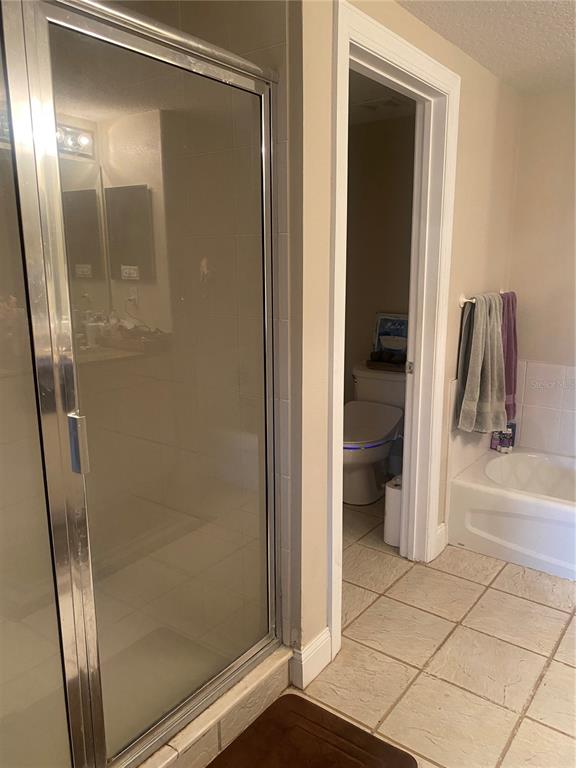 60 Surfview Drive, Unit 121 Palm Coast, FL 32137 - Photo 8 of 13 a bathroom with a glass shower door
