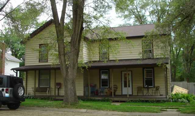 a view of a house with a yard and plants
