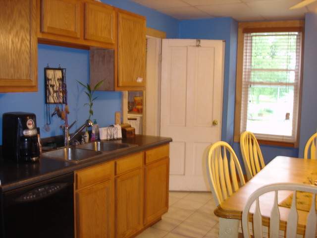 200 South Adams Ridott, IL 61067 - Photo 2 of 9 a kitchen with stainless steel appliances granite countertop a sink and a refrigerator