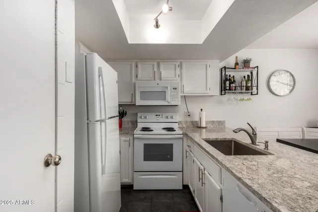 a kitchen with a stove cabinets and refrigerator