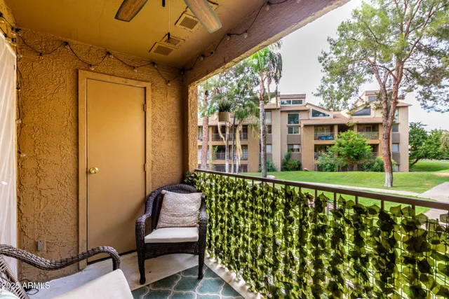 a view of a chair and table in the balcony