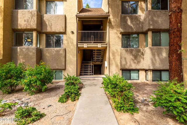 a view of a brick house with large windows