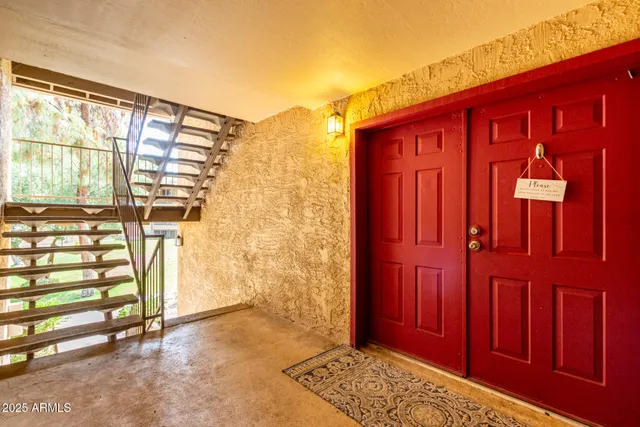 a view of front door with a red door