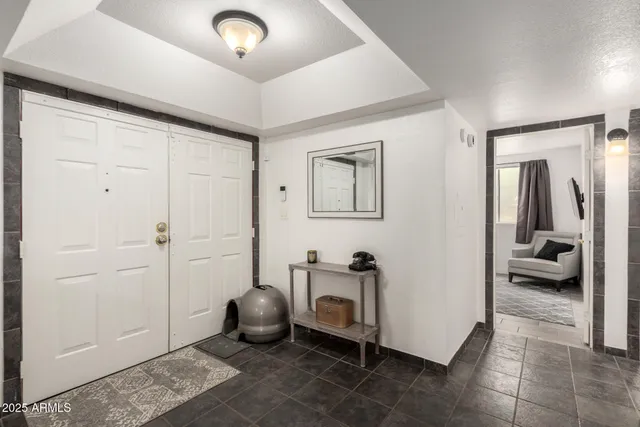 a living room with furniture and a walk in closet