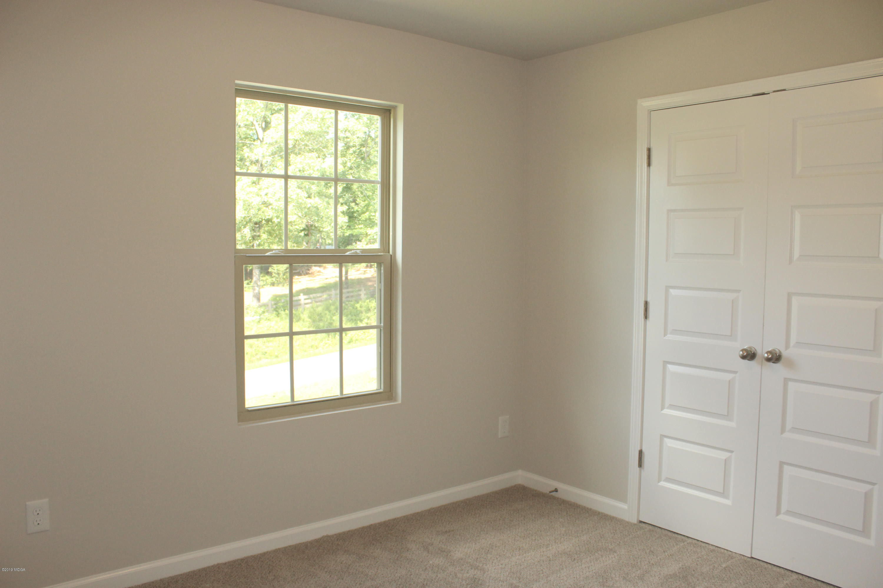 757 Weldon Road Forsyth, GA 31029 - Photo 7 of 8 an empty room with a window