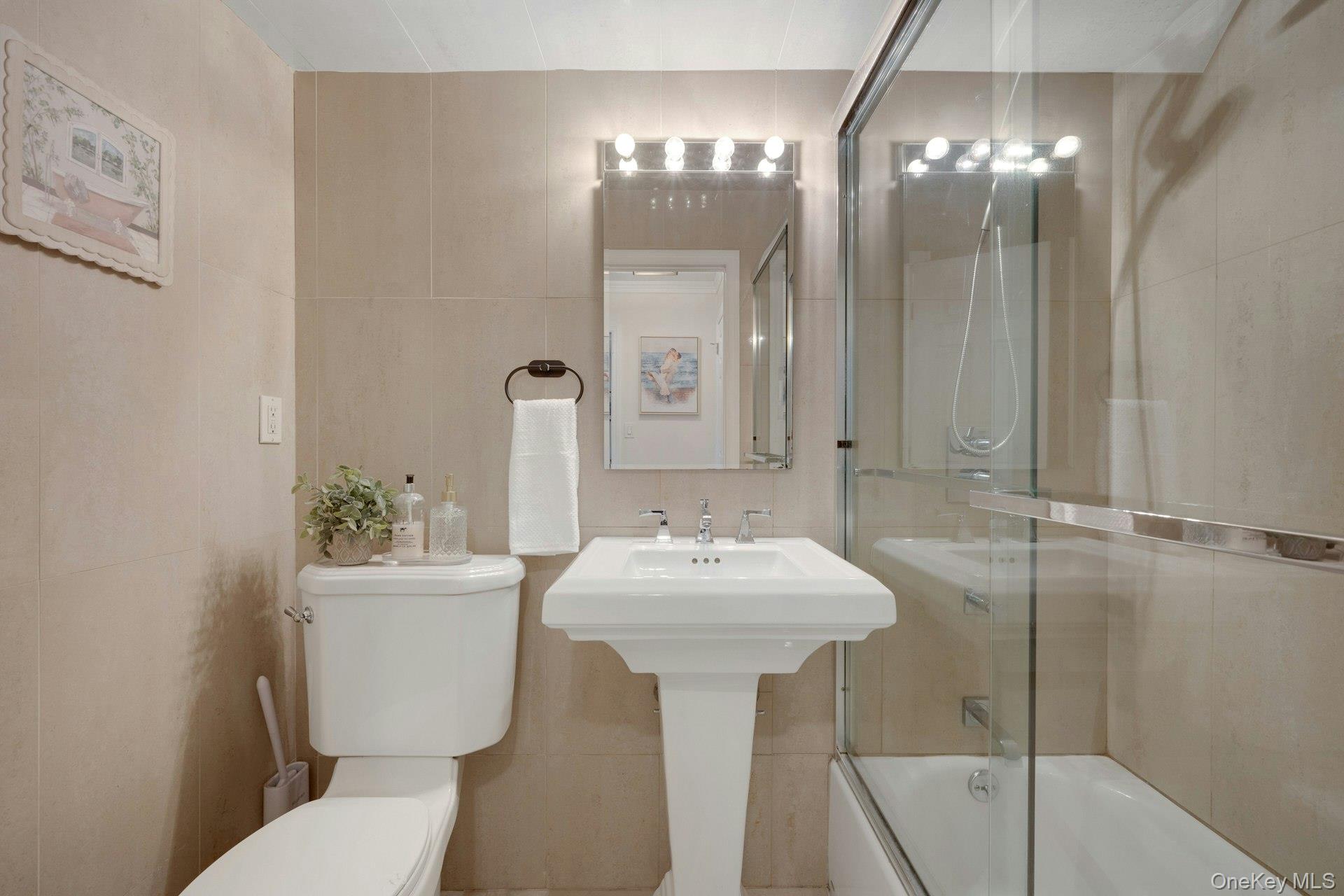 480 Halstead Avenue, Unit 2J Harrison, NY 10528 - Photo 14 of 16 a bathroom with a sink and a mirror