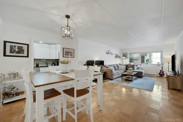 a living room with furniture a flat screen tv and a table