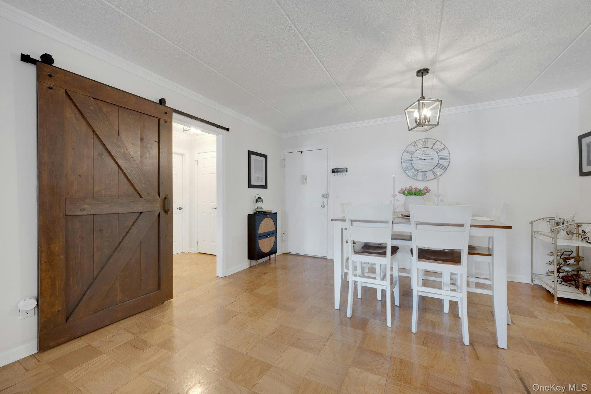 480 Halstead Avenue, Unit 2J Harrison, NY 10528 - Photo 7 of 16 a view of a dining room with furniture and chandelier