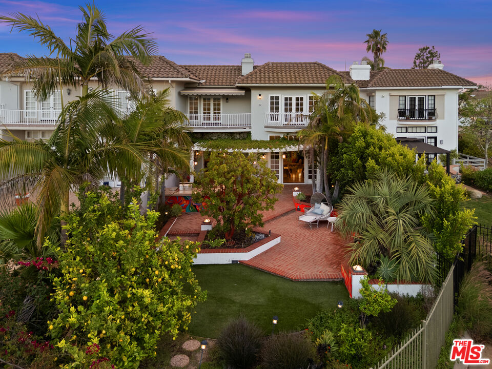 a view of a house with a yard and garden