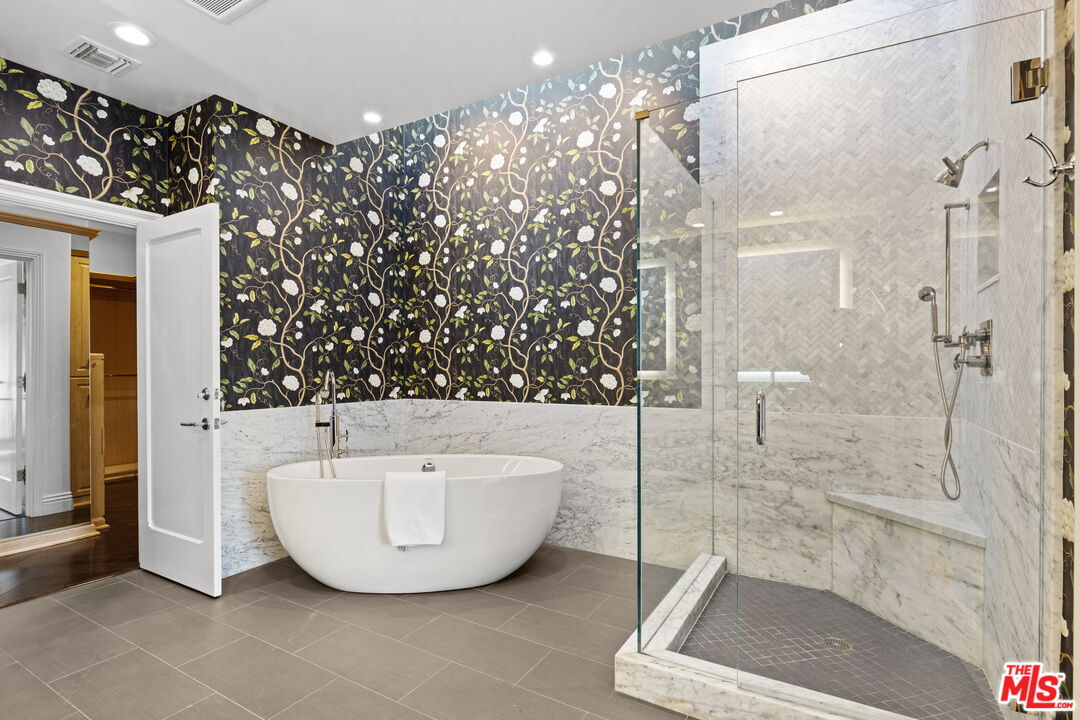 2305 Canyonback Road Los Angeles, CA 90049 - Photo 15 of 26 a bathroom with a bathtub and shower