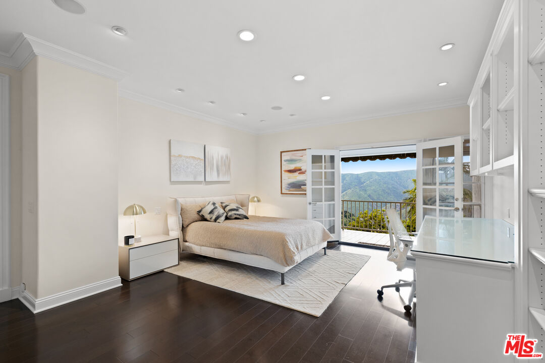 2305 Canyonback Road Los Angeles, CA 90049 - Photo 17 of 26 a bedroom with a bed and a large window