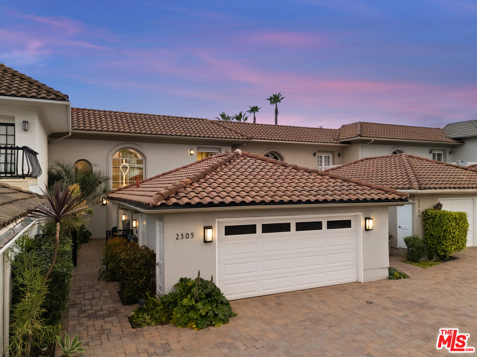 2305 Canyonback Road Los Angeles, CA 90049 - Photo 2 of 26 a front view of a house with garden