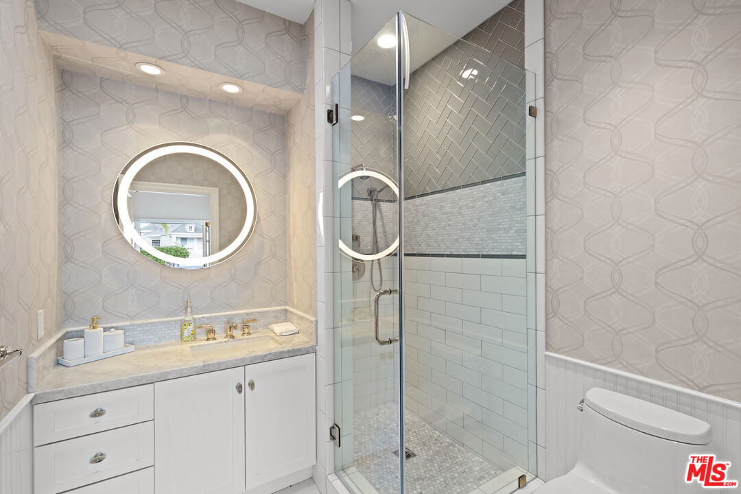 2305 Canyonback Road Los Angeles, CA 90049 - Photo 21 of 26 a bathroom with a sink and a mirror