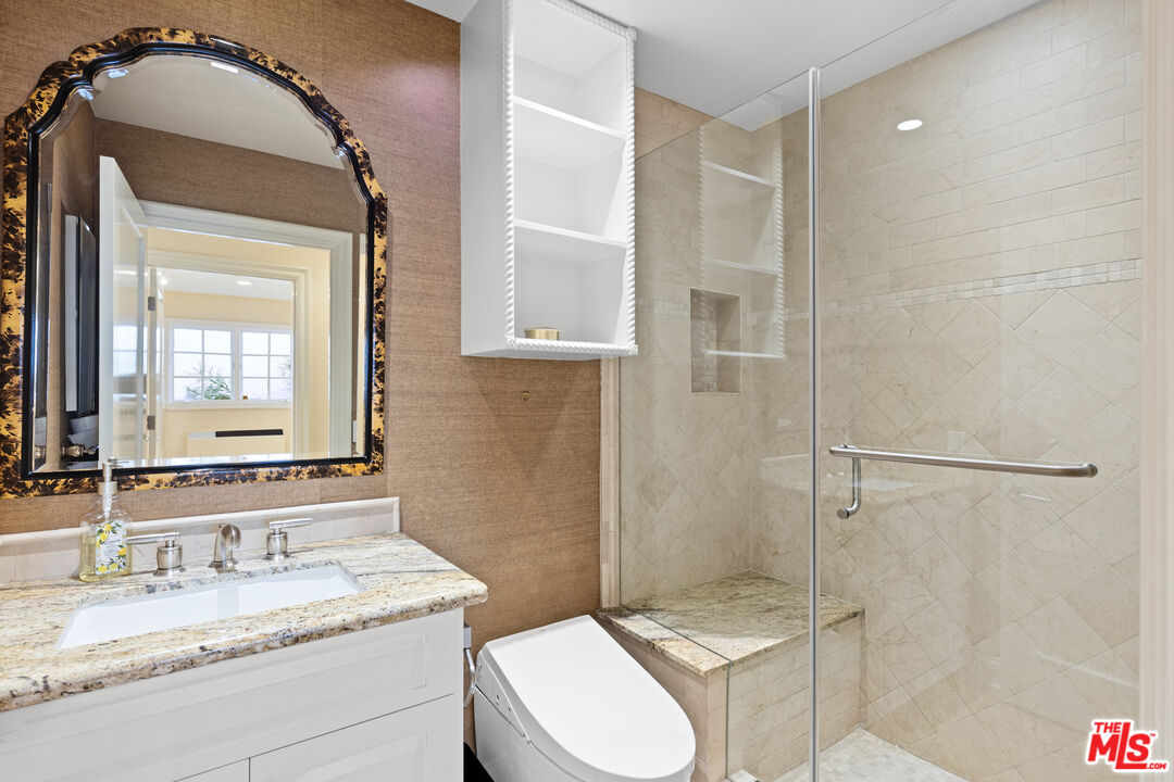 2305 Canyonback Road Los Angeles, CA 90049 - Photo 23 of 26 a bathroom with a granite countertop sink toilet and shower