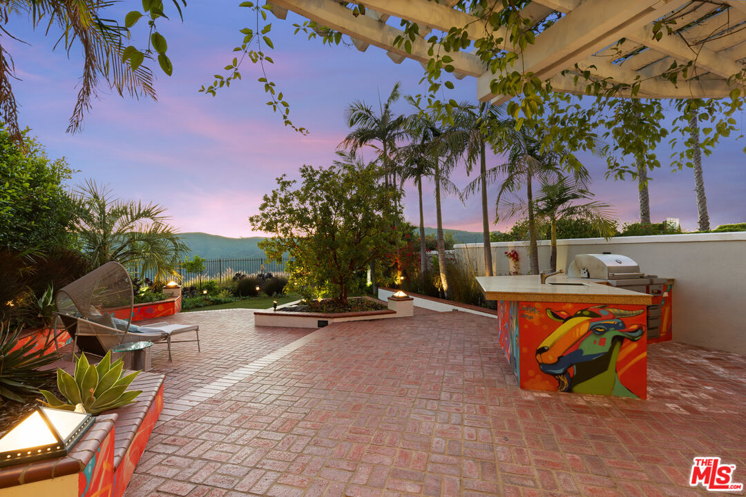 2305 Canyonback Road Los Angeles, CA 90049 - Photo 25 of 26 view of outdoor space with seating area and trees