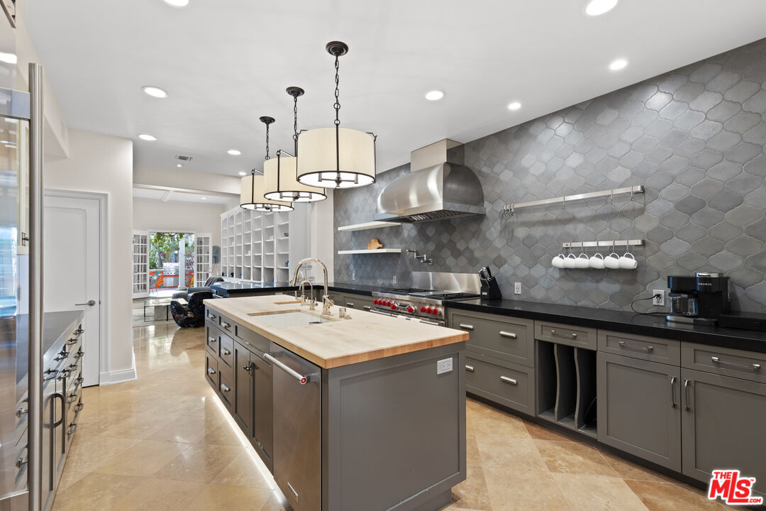 2305 Canyonback Road Los Angeles, CA 90049 - Photo 9 of 26 a kitchen with stainless steel appliances granite countertop a sink a stove and a refrigerator
