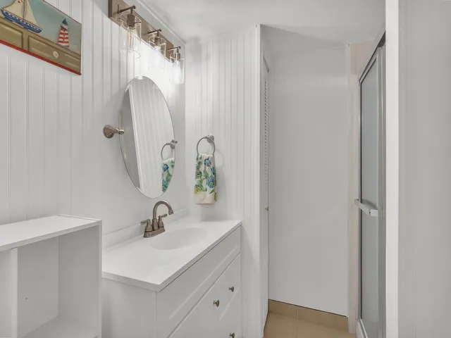 a bedroom with a bed and a night stand