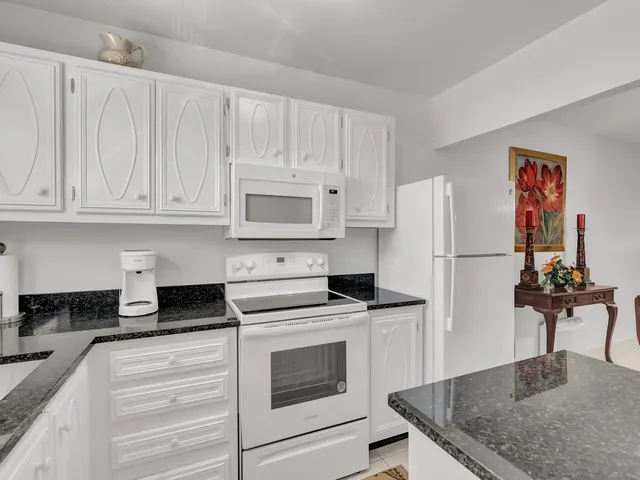 a kitchen with cabinets appliances and a counter space