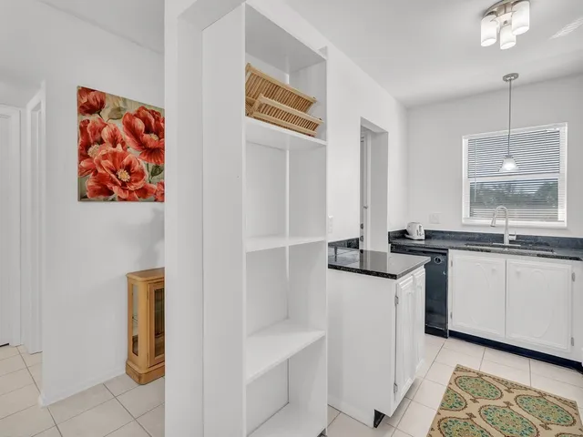 a kitchen with stainless steel appliances a stove a sink and a window