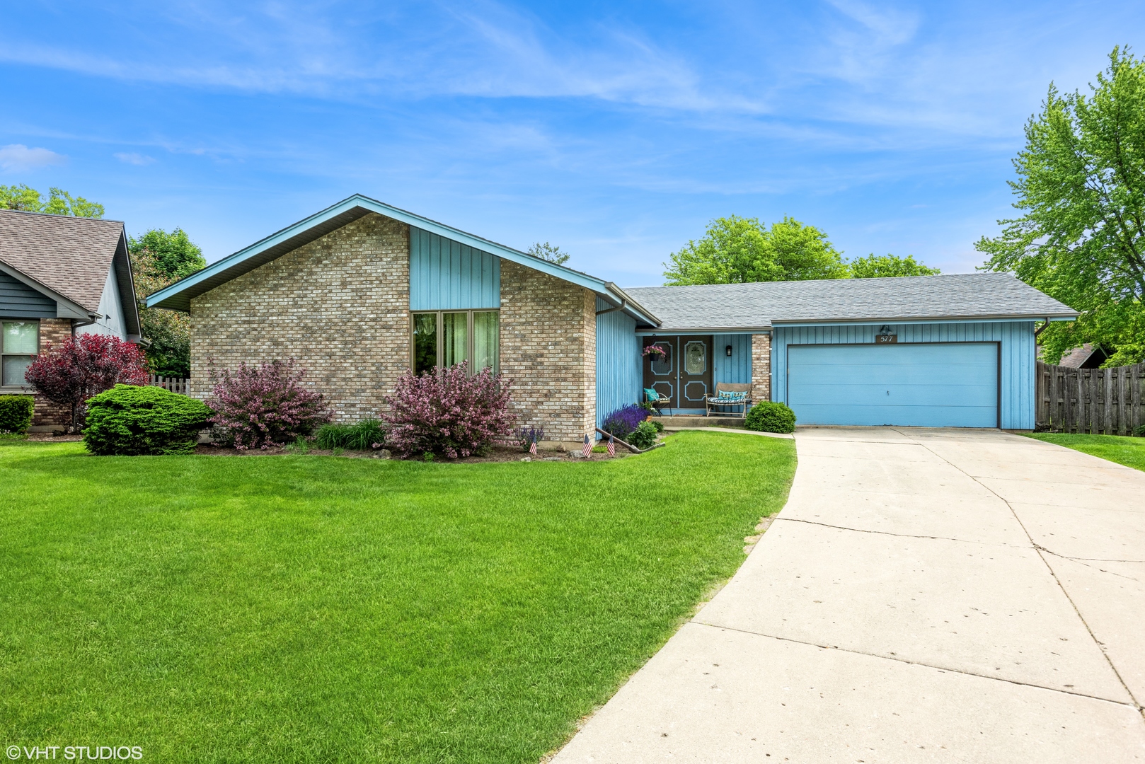 a front view of a house with a garden
