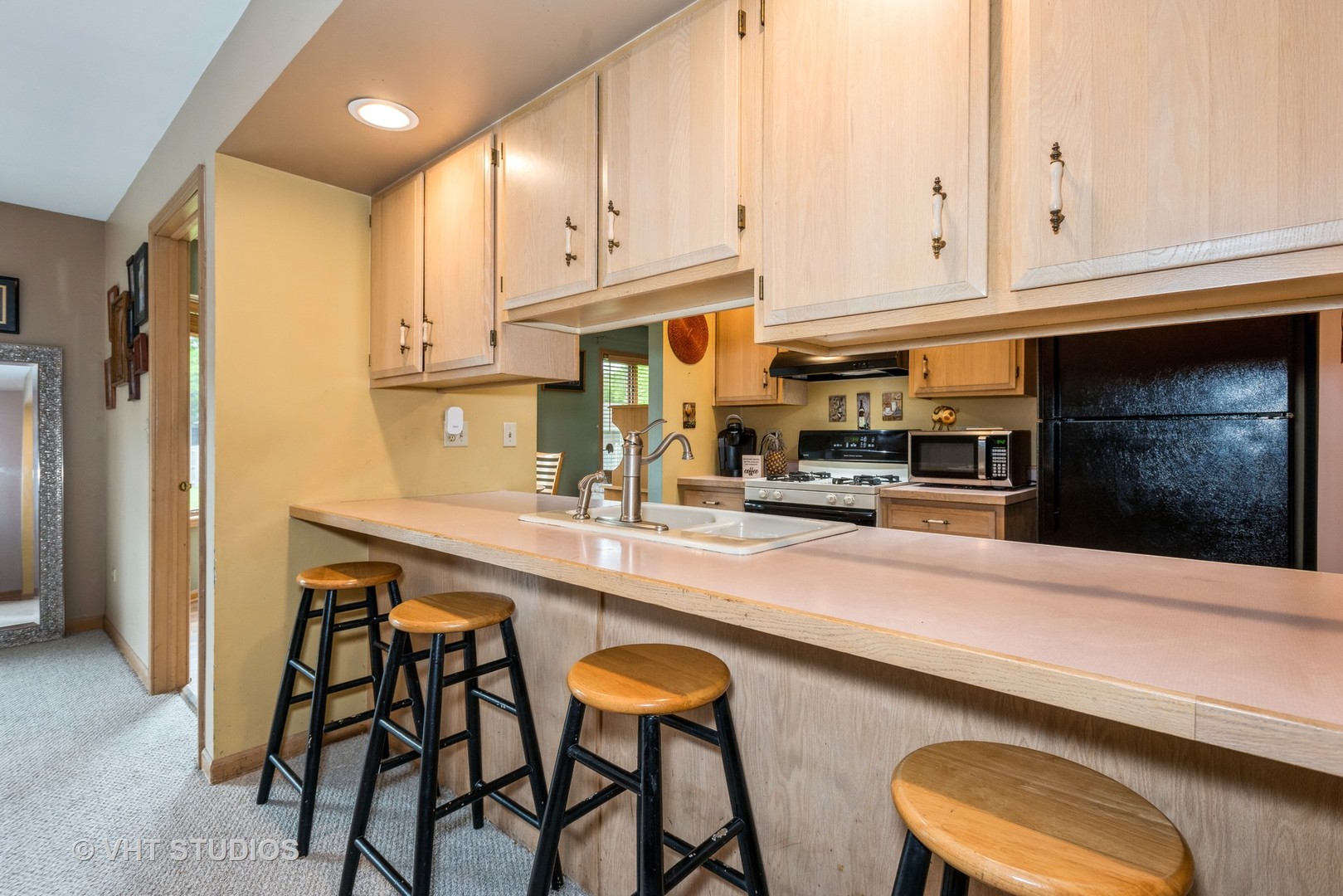 577 Yellowstone Drive Elgin, IL 60123 - Photo 11 of 30 a kitchen with stainless steel appliances a stove a sink and a refrigerator with white cabinets
